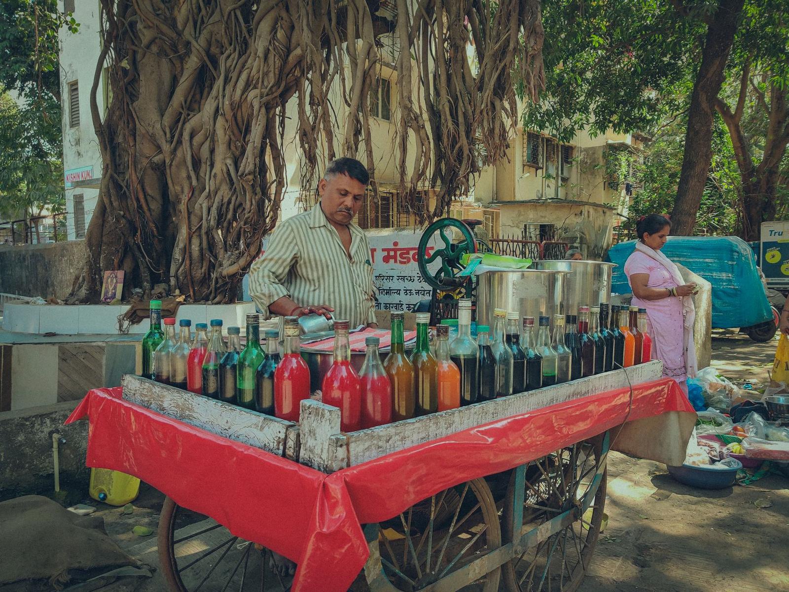 Street Vendor in Mumbai Selling Colorful Syrups